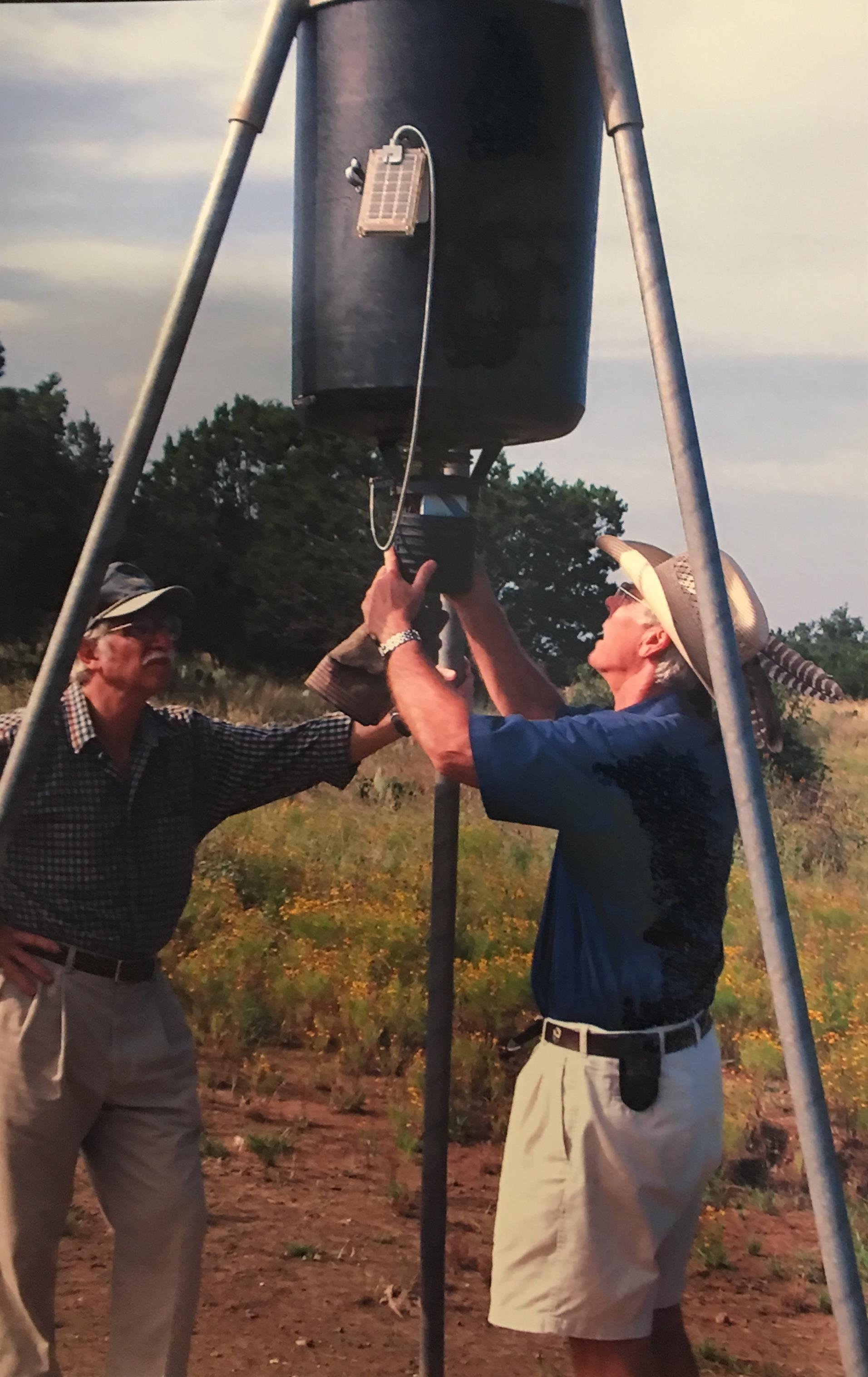 Checking a deer feeder with Harris Greenwood in Johnson City, 2004