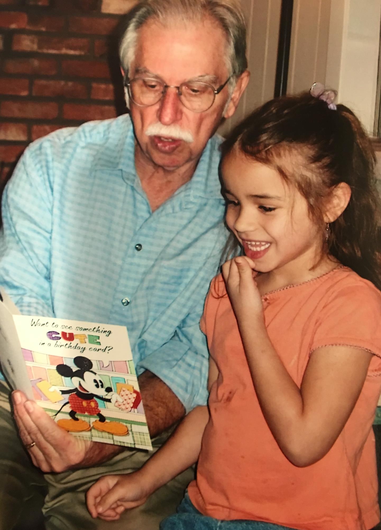 Passing along his love of reading to granddaughter Dominique, January, 2007