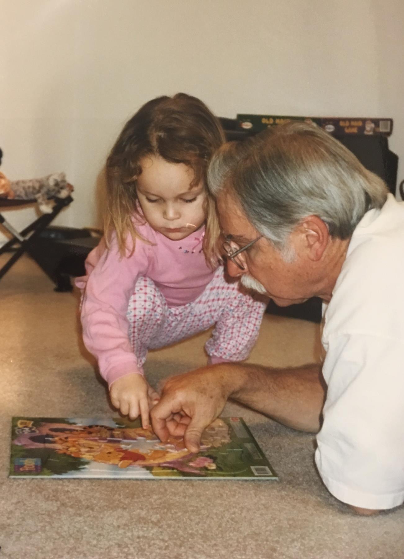 Mackenzie and her beloved Granddaddy solving a puzzle.