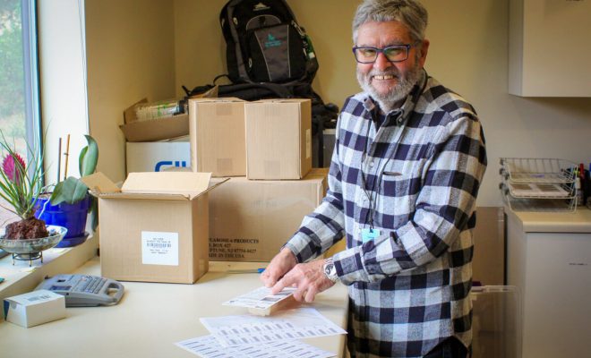 A GDB volunteer doing some work in an office.