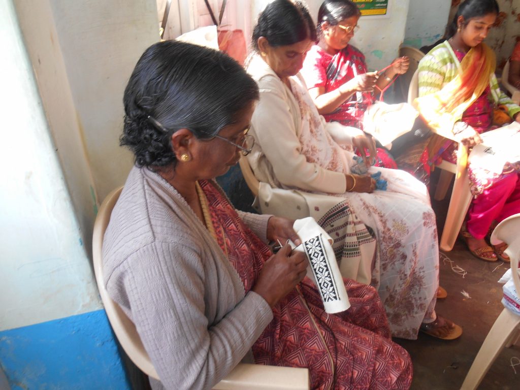 A toda woman embroidering on cloth
