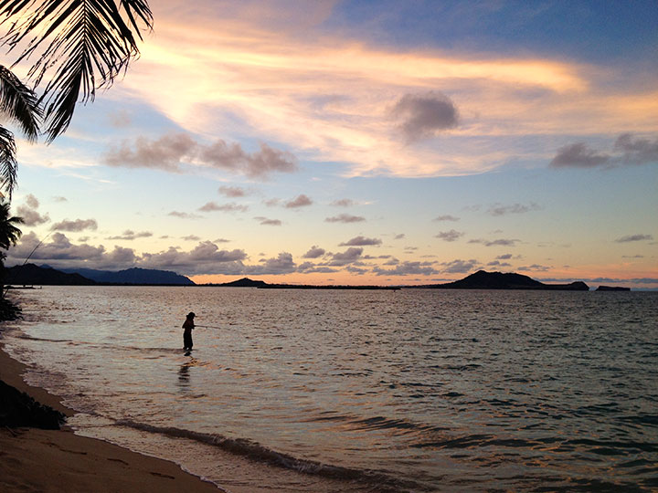Fisherman at sunset on Lanikai Beach, Kailua, Oahu. Photo courtesy of Napua Heen.