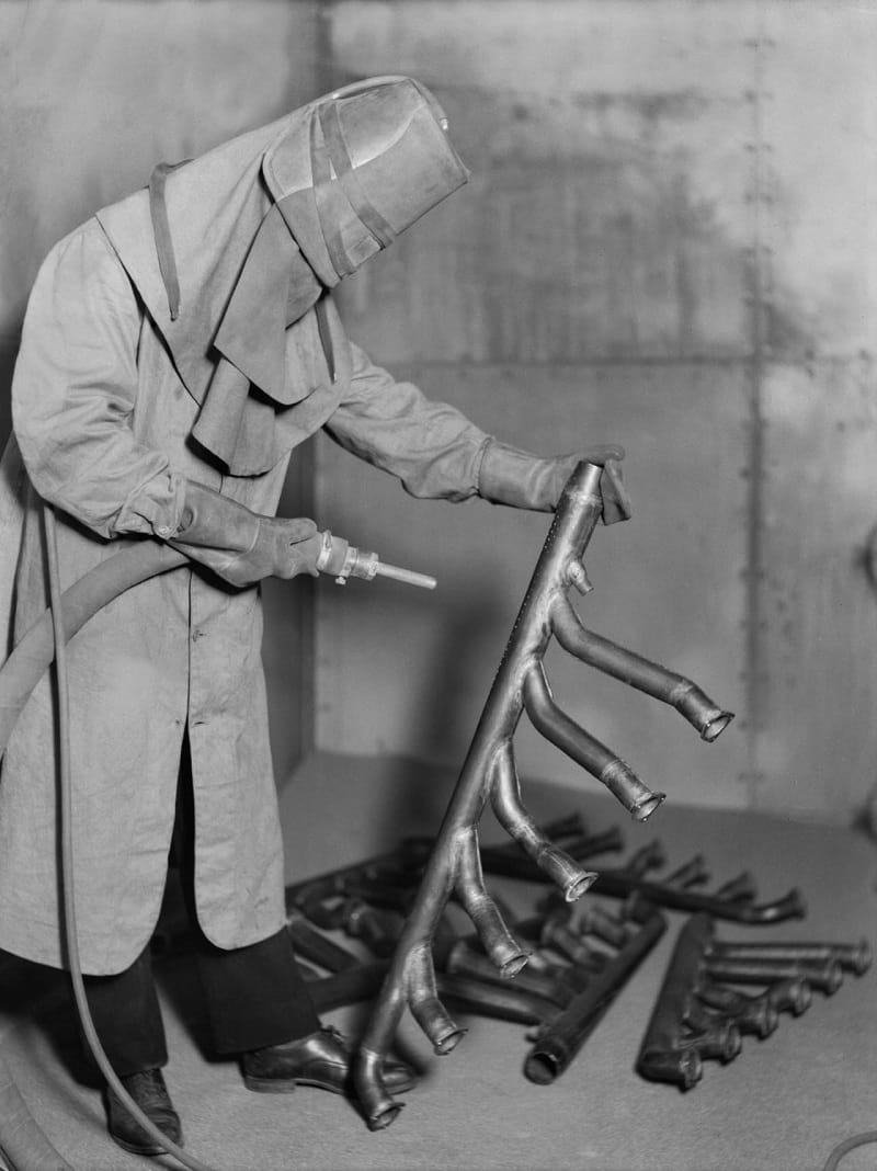 Sandblasting engine manifolds in the 1930s photo