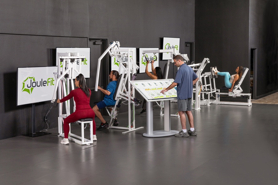 Members training on JouleFit AI robotic machines in the studio