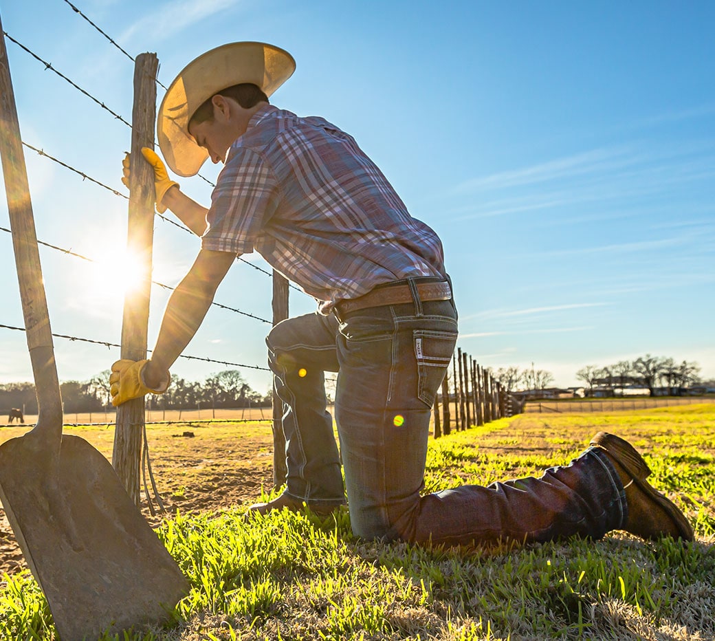 Rancher fixing a fence.
