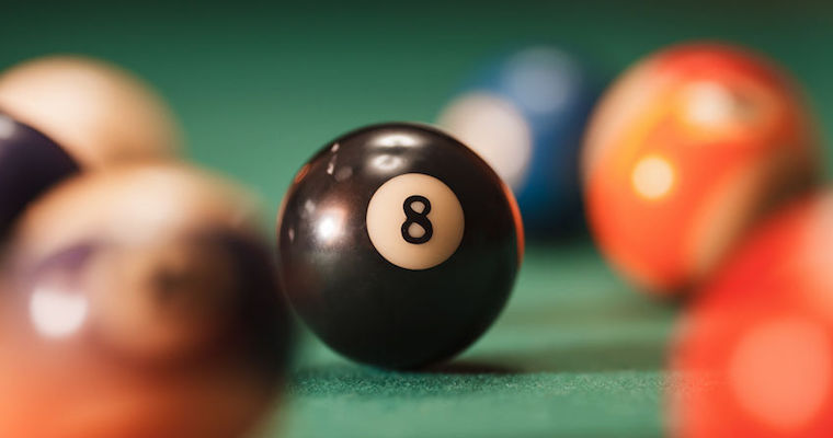 black 8 ball on a pool table