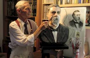 Sculptor Howard Lazar working on bust of Peter Donahue