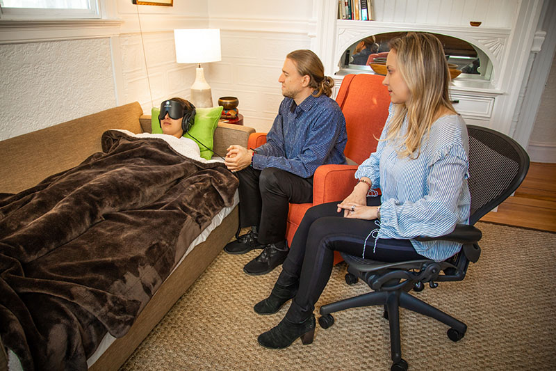 Veronika Gold and Eric Sienknecht attend to a therapy participant