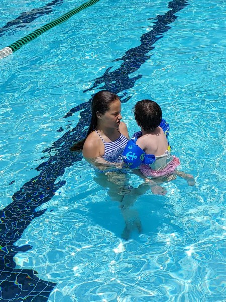 Kam teaching her cousin to swim