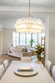 Stunning chandelier over dining room matches entry