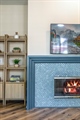 Custom fireplace with millwork and designer tile 