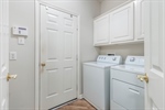 Laundry room leads to garage with utility sink.