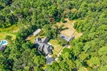 Overhead view shows woods to rear