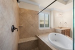 Huge walk-in shower next to soaker tub