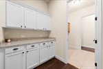 Mudroom adjacent to garage wtih storage