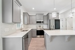 Stainless steel appliances including refrigerator.