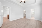 Refreshing lighted ceiling fan and walk in closet.