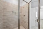 The shower is complete with accoutrement niche.