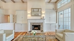 Woodburning fireplace with custom wood mantle and 