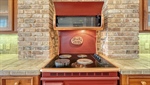 Cast iron Elmira stove in kitchen surrounded by Ch