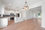 The great room is open to the dining and kitchen.