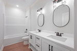 Second full bath. Double vanity. Shower over tub.