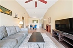 Great room with vaulted ceiling and fan.