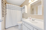 Private full ensuite bath with a shower over tub.