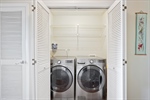 Laundry area located between the two bedrooms.
