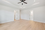 Stunning ship lap tray ceiling with lighted fan.