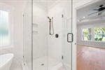 Walk in tiled shower.