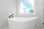 Separate free standing soaking tub.