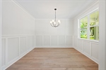 Formal dining room with chandelier lighting.
