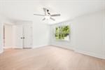 Lighted ceiling fan and walk in closet.
