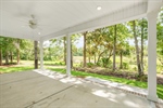 Large covered patio on the back of the home.