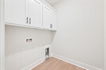 Main level laundry room with built in cabinetry.