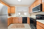 Abundant cabinetry and black appliances.