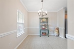 Dining room with chandelier lighting.