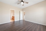 Luxury vinyl plank flooring and ceiling fan.