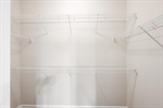 Walk in closet with built in shelving.