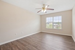 Lighted ceiling fan and walk in closet.
