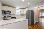 Modern kitchen with SS appliances and quartz