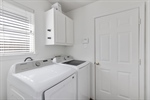 Laundry room with window near garage entry