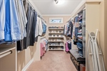 Walk in closet with built in shelving.