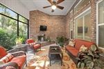 Outdoor screen room with fireplace.