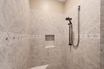 Walk in tiled shower.