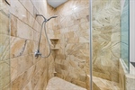 Oversized shower with frameless glass surround.