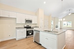 Kitchen with island and abundant white cabinetry.
