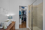 Tiled shower and walk-in closet