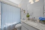 Hallway bathroom with tiled tubshower